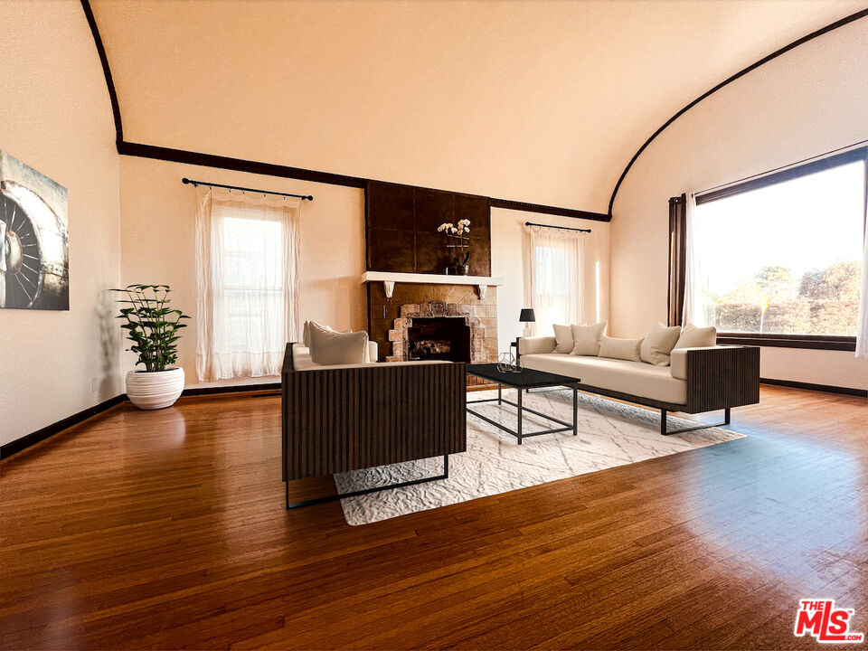 6187 Barrows Drive Los Angeles, CA 90048 - Photo 3 of 35 a living room with furniture and a fireplace