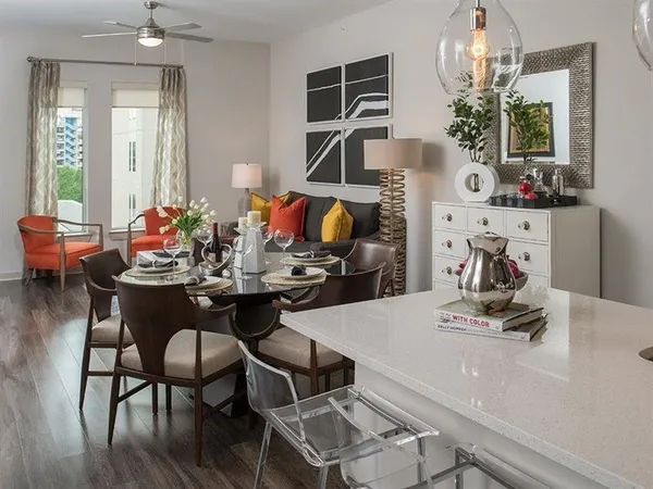 a kitchen with a table chairs and a refrigerator