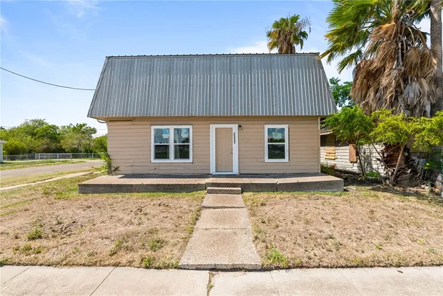 a front view of a house with garden