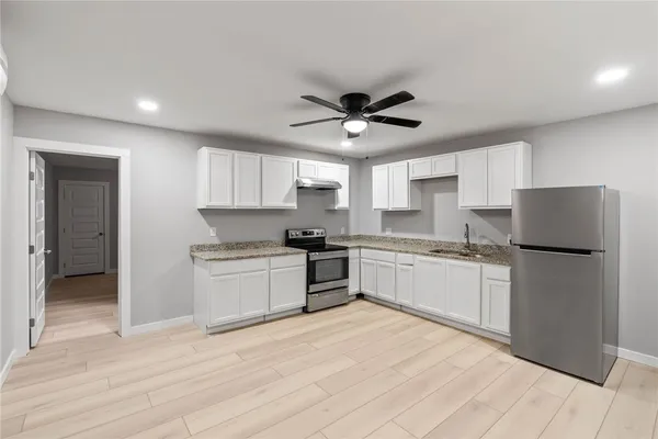 a kitchen with a refrigerator a sink and dishwasher