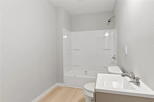 a bathroom with a sink a toilet and bathtub