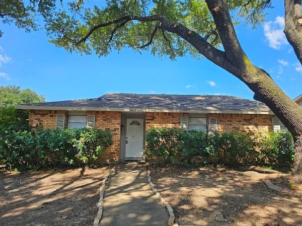 a view of a house with a tree in a yard