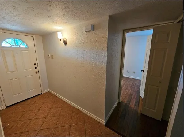 a view of hallway with wooden floor