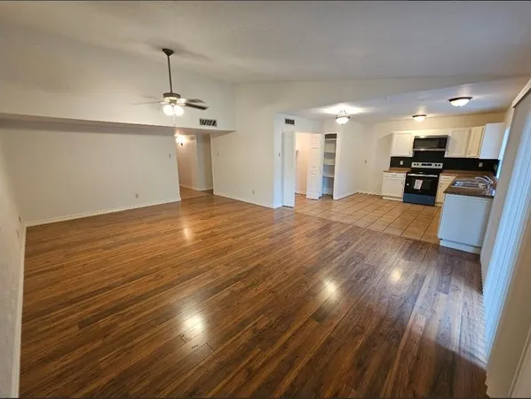 a kitchen with stainless steel appliances granite countertop a refrigerator and a stove