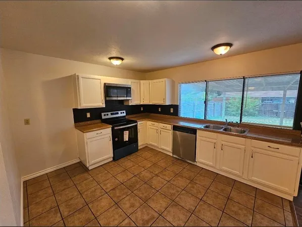 a view of a livingroom with wooden floor and cabinet