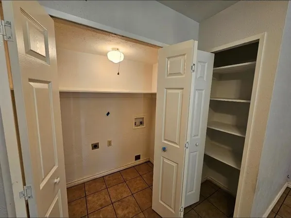 a view of a room with wooden floor and fan
