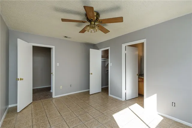 a view of an empty room with a ceiling fan
