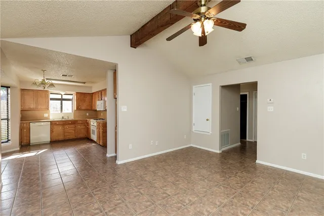 a view of a kitchen with a sink and a refrigerator