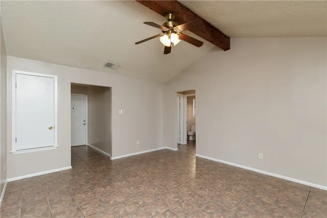 a view of a livingroom with a ceiling fan and window