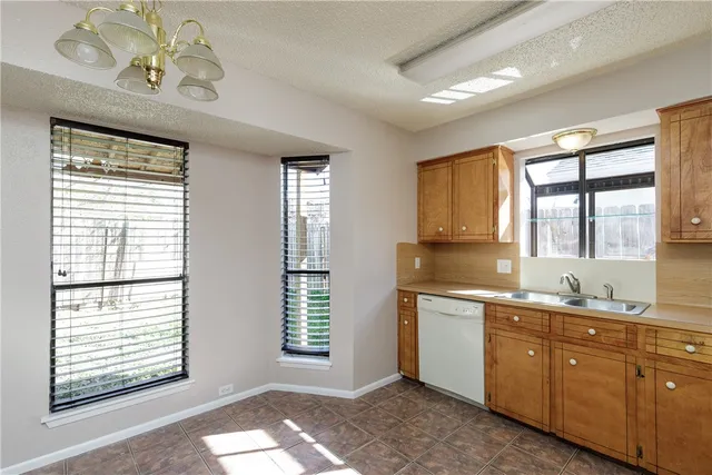 a spacious bathroom with a granite countertop sink mirror and a large window
