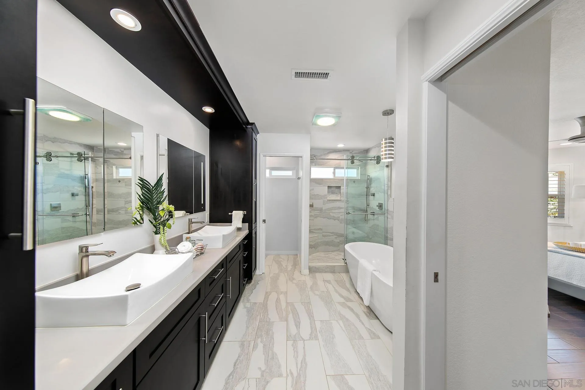 1971 Avenida Joaquin Encinitas, CA 92024 - Photo 18 of 33 a bathroom with a double vanity sink and mirror with shower