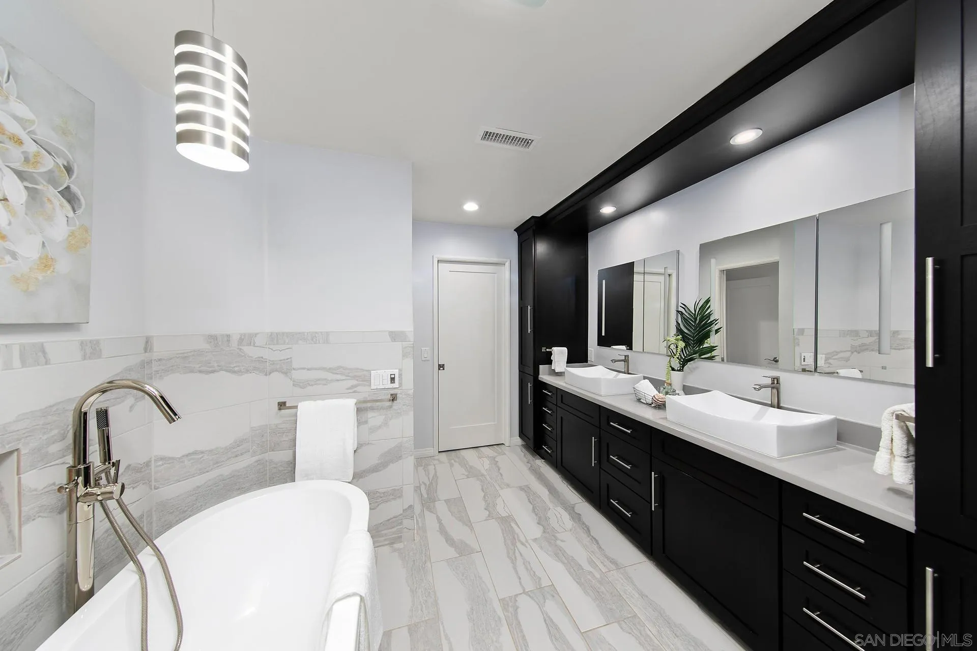 1971 Avenida Joaquin Encinitas, CA 92024 - Photo 19 of 33 a spacious bathroom with a double vanity sink a mirror and a bathtub