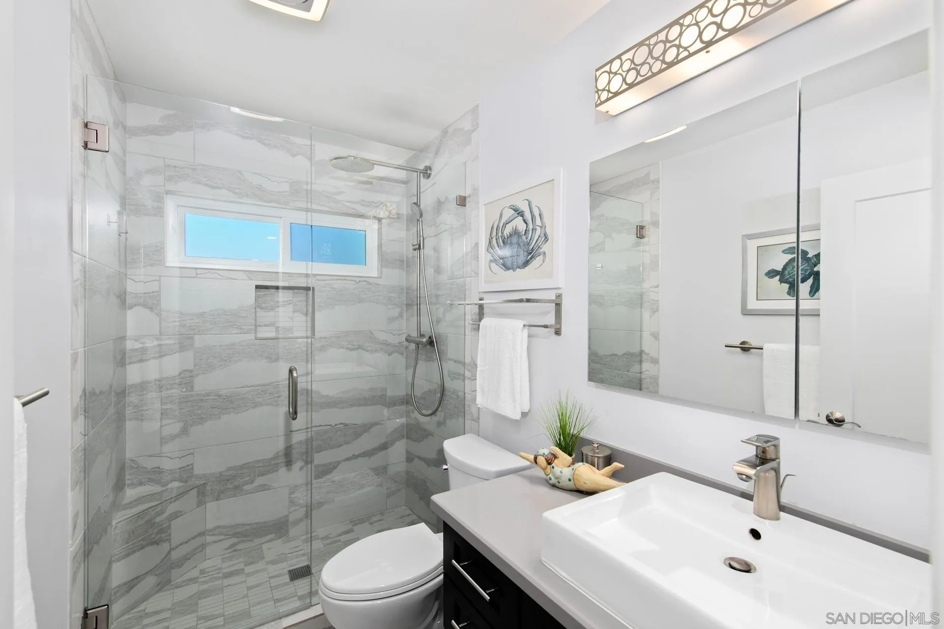 1971 Avenida Joaquin Encinitas, CA 92024 - Photo 22 of 33 a bathroom with a sink toilet and shower