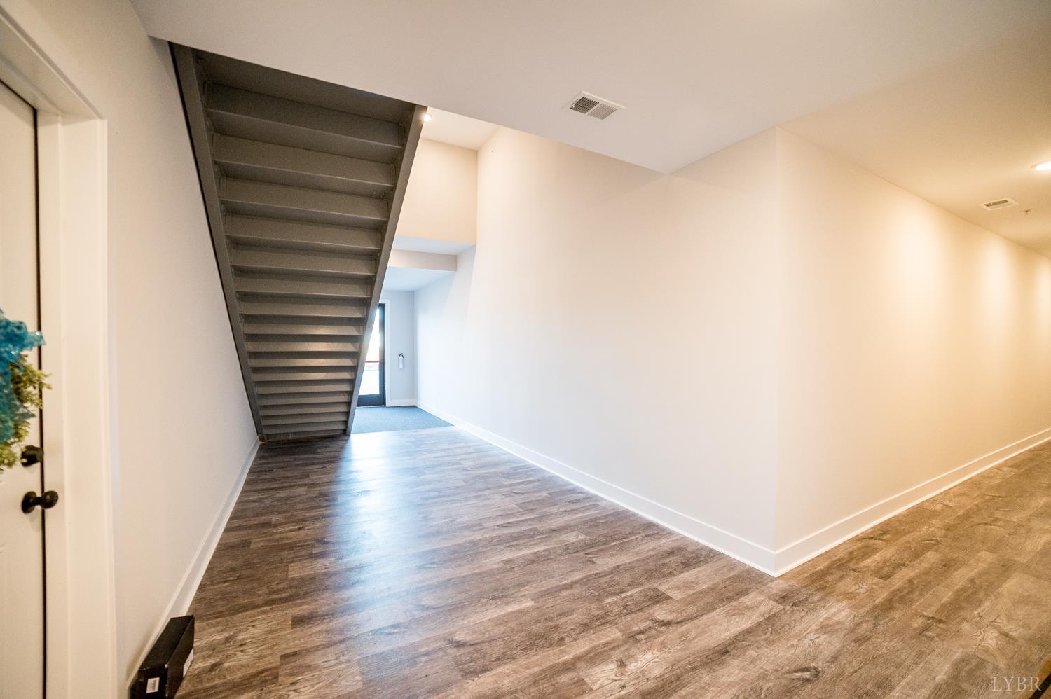 1300 Stoney Ridge Boulevard, Unit 101 Forest, VA 24551 - Photo 12 of 18 a view of a hallway with wooden floor