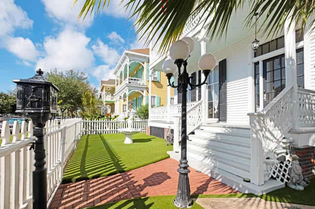 a view of a patio with couches table and chairs and potted plants
