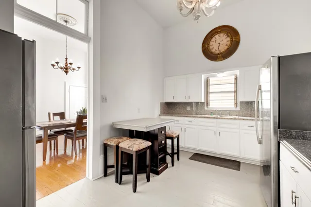 a kitchen with a refrigerator and a stove top oven