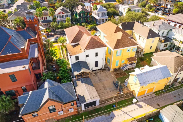 an aerial view of a house with swimming pool and outdoor seating