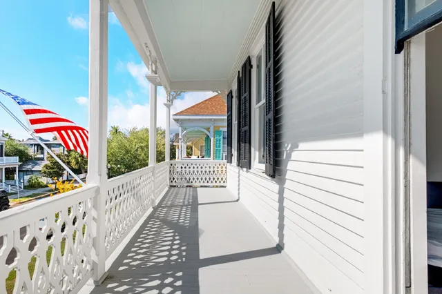a view of a street with wooden fence