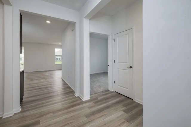a view of a hallway with wooden floor