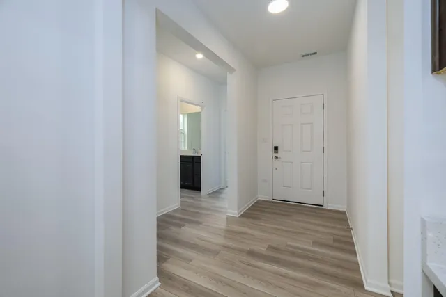 a view of an empty room with wooden floor