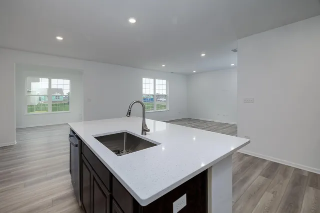 a kitchen with a sink a counter space and a window