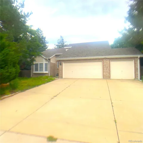 a view of house with backyard