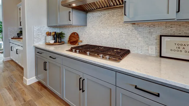 a kitchen with stainless steel appliances a stove and cabinets
