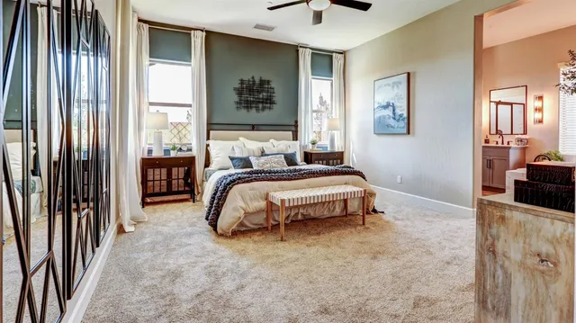 a bedroom with a bed and a flat tv screen next to a window