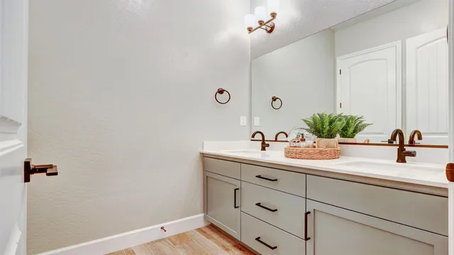 a bathroom with a sink and a mirror