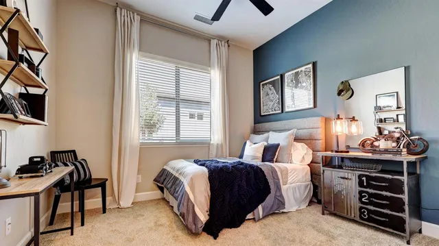 a bedroom with a bed and a window