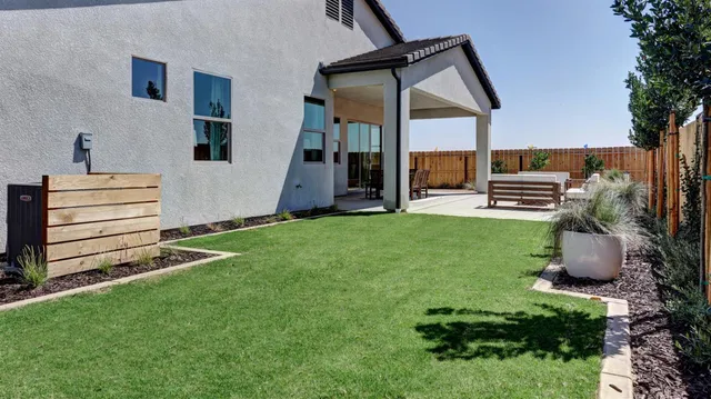 a view of a backyard with sitting area