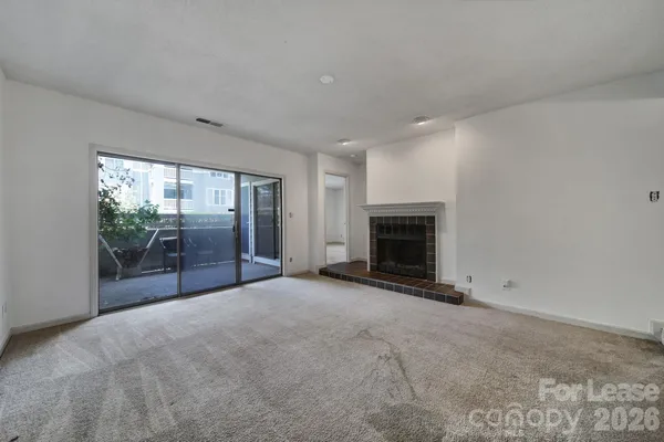 a view of empty room with a fireplace