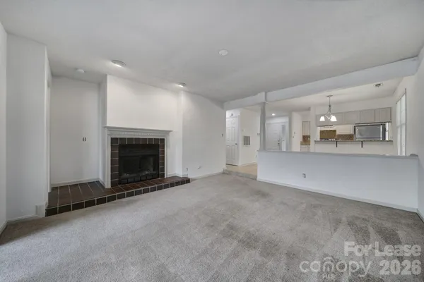 a view of a kitchen with a sink and a refrigerator