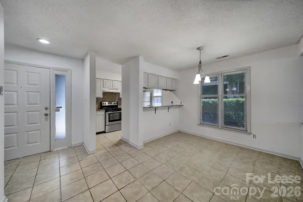 a view of a kitchen with a refrigerator and window