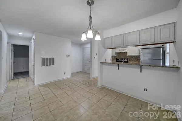 a view of a kitchen with microwave and cabinets