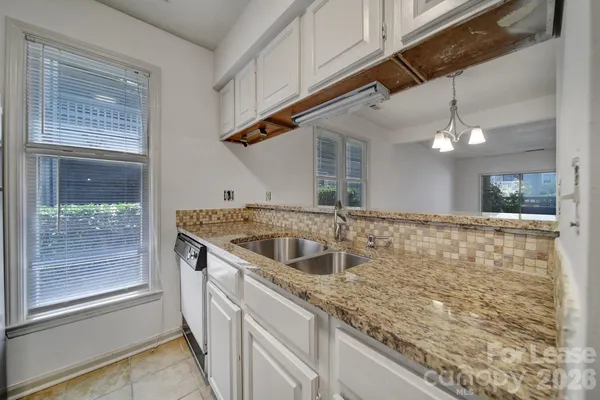 a kitchen with a sink and a shower