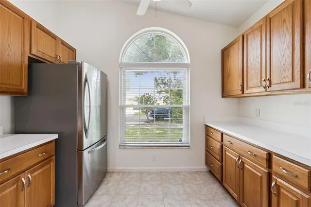 a kitchen with stainless steel appliances a refrigerator sink and microwave