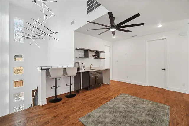 a kitchen with stainless steel appliances kitchen island in the background