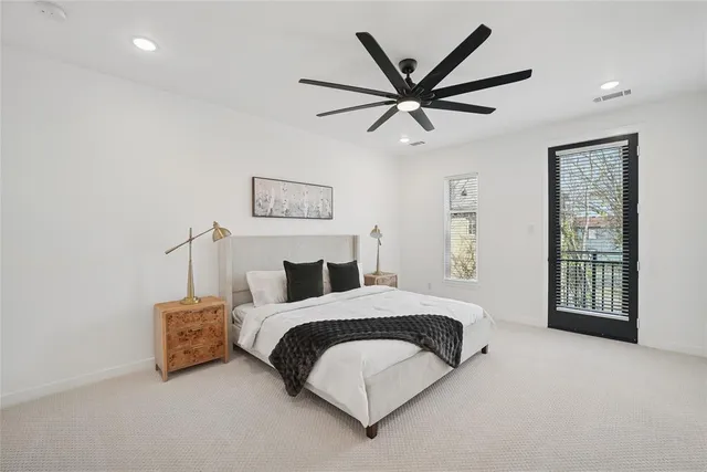 a bedroom with a bed a couch and a window