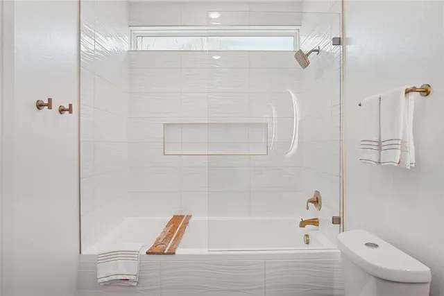 a bathroom with a bathtub and a shower