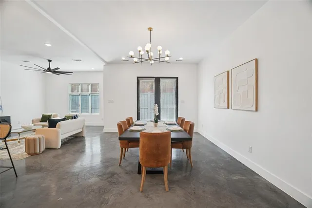 a view of a dining room with furniture and chandelier