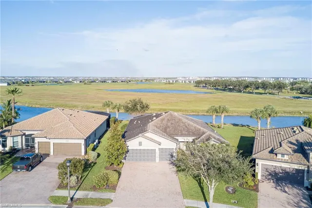 an aerial view of a house with outdoor space and lake view