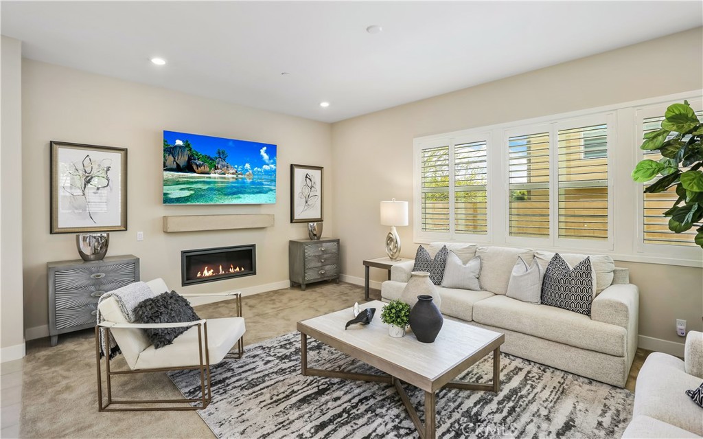 117 Swift Irvine, CA 92618 - Photo 7 of 62 a living room with furniture a flat screen tv and a fireplace