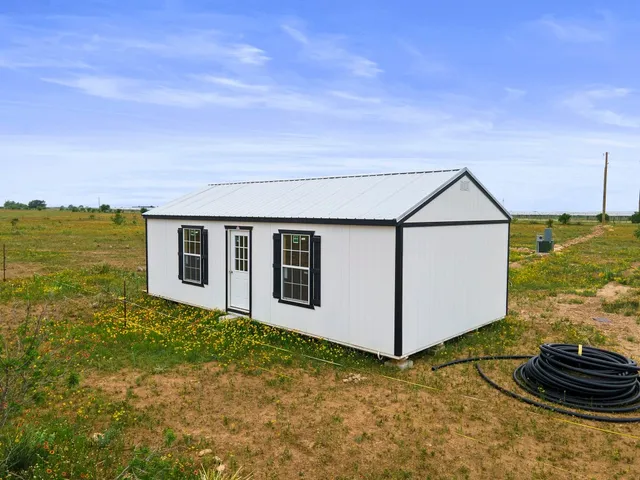 a backyard of a house with wooden fence