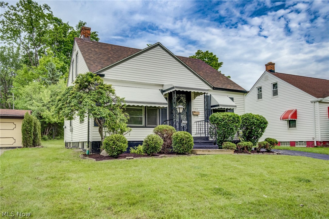 4383 Wyatt Road Cleveland, OH 44128 - Photo 32 of 33 White siding residence with a dark shingle roof and a covered entry featuring wrought iron detailing
