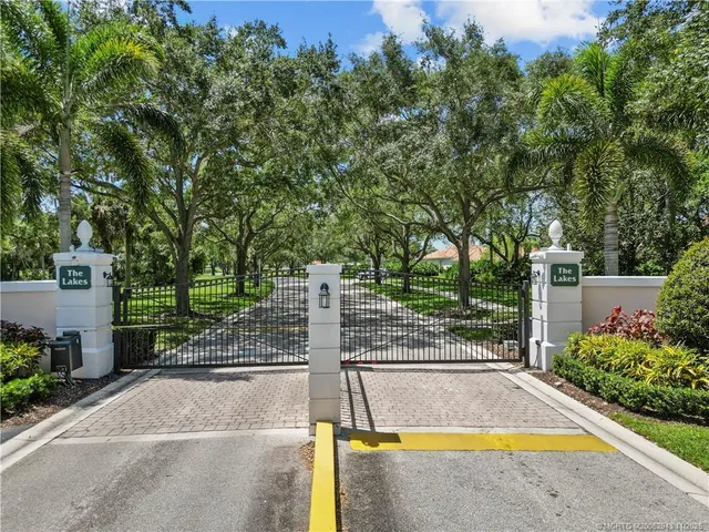a view of yard with swimming pool and trees in the background