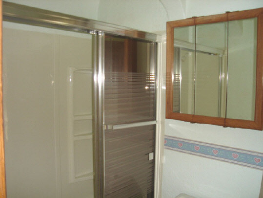 3452 Prairie Road Rockford, IL 61102 - Photo 4 of 6 a bathroom with a glass shower door and a shower