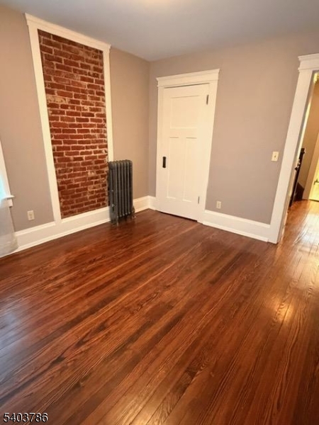 19 Academy Road Morris Plains, NJ 07950 - Photo 23 of 39 a view of an empty room with wooden floor and a window