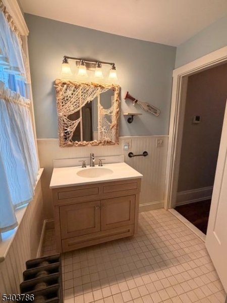 19 Academy Road Morris Plains, NJ 07950 - Photo 24 of 39 a bathroom with a tub sink and mirror