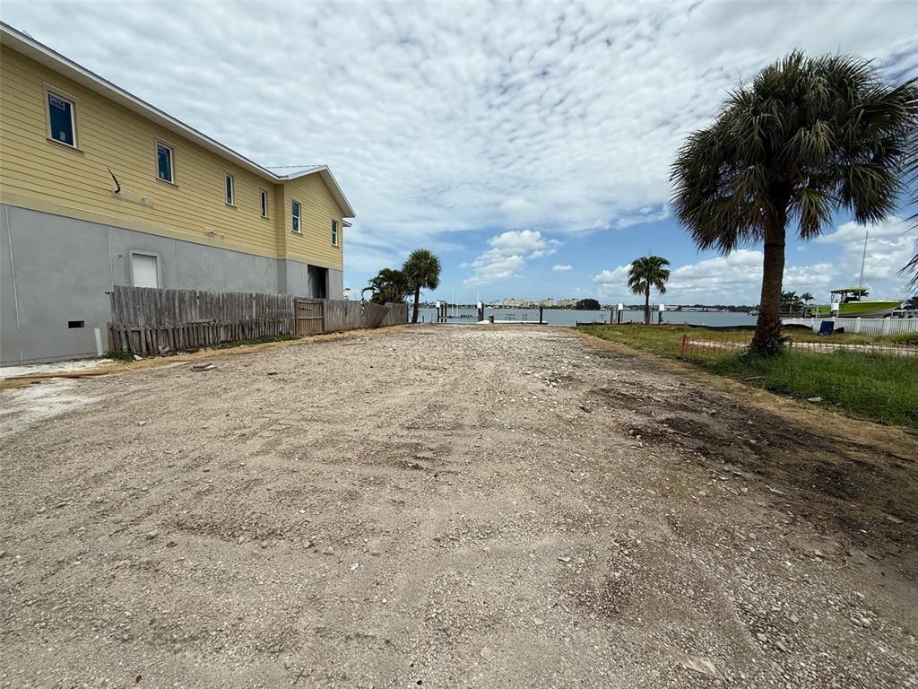 14217 East Parsley Drive Madeira Beach, FL 33708 - Photo 2 of 3 a row of palm trees in front of house